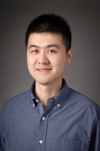 A person in a blue shirt  Description automatically generated